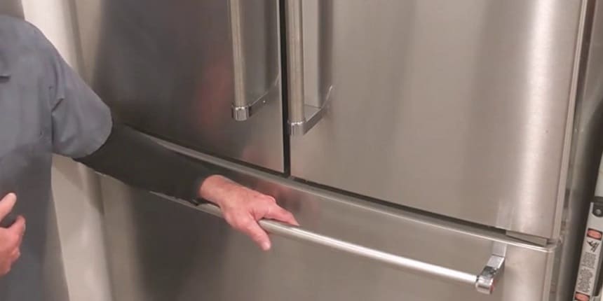 Handling freezer door to remove freezer door